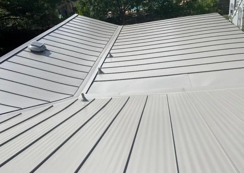 Solar attic fan installed on a metal roof for Roof Ventilation in Odessa